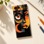 Abstract portrait mobile skin with orange geometric face in creative desk flat lay
