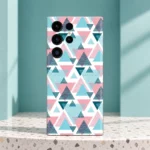 Pink, turquoise and deep teal abstract triangle pattern mobile skin on a white background, teal terrazzo setting