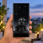Black Adiyogi starry night mobile skin held upright on a twilight balcony