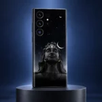 Adiyogi black starry night mobile skin on a charcoal plinth against an indigo studio background