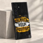 Always Keep Positive quote mobile skin in black, yellow and white, pale concrete studio view