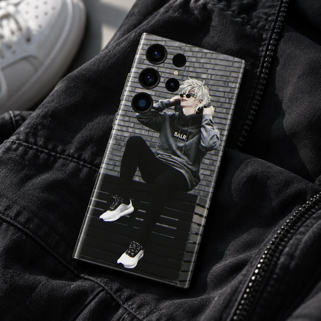 Anime Boy Streetwear Mobile Skin - Streetwear flat lay Anime Boy Streetwear Mobile Skin shown back-up on dark fabric beside a blurred white sneaker