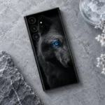 Dark Arctic Wolf portrait mobile skin with detailed grey fur and one vivid blue eye, cool stone flat lay