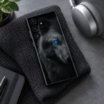 Dark Arctic Wolf portrait mobile skin with detailed grey fur and one vivid blue eye, charcoal desk lifestyle