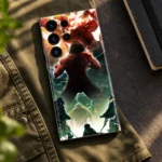 Attack on Titan Battle Mobile Skin lying on olive canvas beside a notebook
