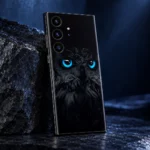 Black owl mobile skin with vivid cyan-blue eyes and charcoal feather artwork, dark stone detail view