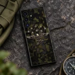 Olive camouflage mobile skin with a gold eagle and eight stars, outdoor flat lay