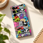 Cartoon Music Doodle Mobile Skin shown in daylight headphone flat lay