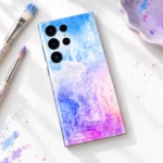 Colorful Art mobile skin on an artist desk beside brushes