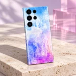 Colorful Art mobile skin displayed on pale travertine with pink acrylic