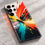 Colorful mobile skin with orange, yellow, teal and black paint splash artwork, close detail