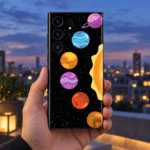 Colourful Planets Mobile Skin held against a dusk rooftop backdrop
