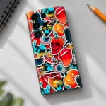 Colourful mobile skin with cartoon skulls, pumpkins and pop art stickers, creative desk flat lay