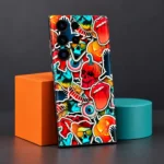 Colourful mobile skin with cartoon skulls, pumpkins and pop art stickers, geometric studio display