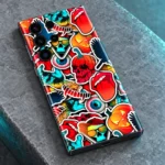 Colourful mobile skin with cartoon skulls, pumpkins and pop art stickers, stone detail