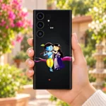 Cute Radha Krishna mobile skin held in a blooming garden courtyard