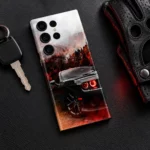 Dodge Demon mobile skin with a black muscle car, red headlights and autumn forest, leather desk flat lay