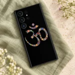 Floral Om symbol mobile skin with colourful rosettes on black in a sage linen flatlay