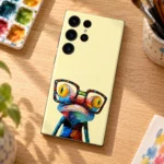 Pale yellow Frog With Glasses Mobile Skin with colorful frog artwork, artist desk flat lay
