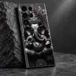 Close view of ornate Ganesha crown and curved trunk artwork on black and silver mobile skin
