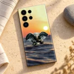 Lord Ganpati sunset water mobile skin with bronze Ganesha idol – sandstone flat lay