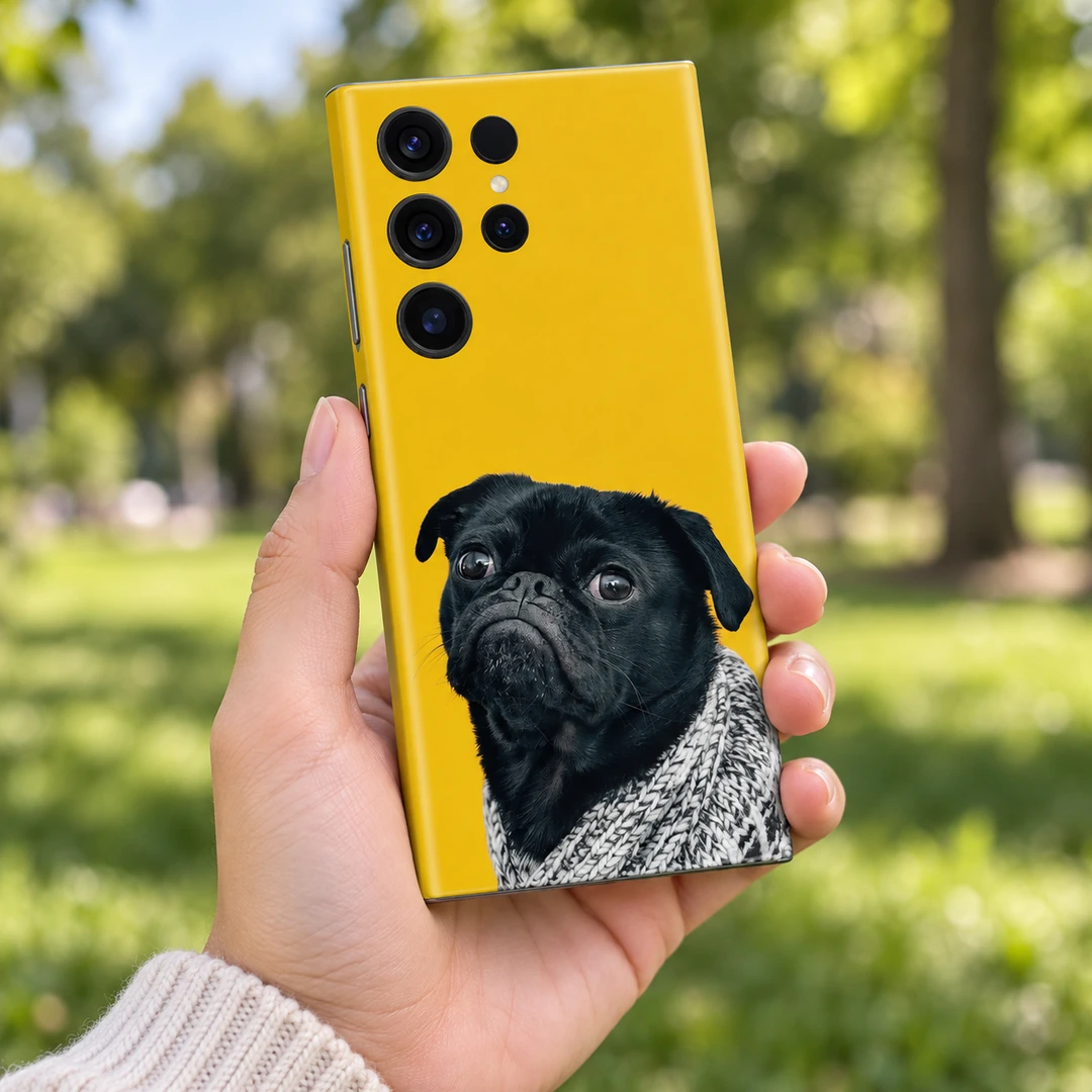 Grumpy Black Pug Mobile Skin - Park handheld Yellow mobile skin featuring a grumpy black pug in a grey knitted blanket - park handheld