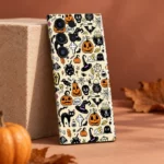 Halloween pattern mobile skin with pumpkins, witch hats and black cats on cream, terracotta sandstone studio view