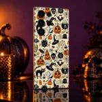 Halloween pattern mobile skin with pumpkins, witch hats and black cats on cream, plum reflective studio view