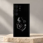 Hanumanji face white line art mobile skin on black displayed on an ivory pedestal