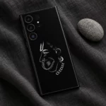 Black Hanumanji face mobile skin flat lay on charcoal linen