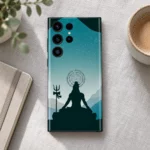Har Har Mahadev teal mountain mobile skin on linen beside a notebook and cup