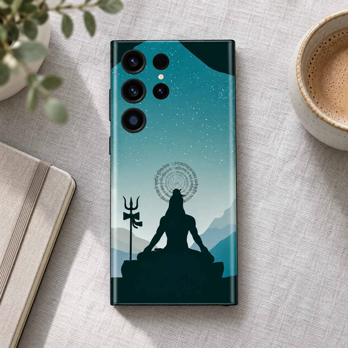 Har Har Mahadev Teal Mountain Meditation Mobile Skin - Calm desk flatlay Har Har Mahadev teal mountain mobile skin on linen beside a notebook and cup