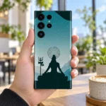 Har Har Mahadev teal meditation mobile skin held in a bright airy cafe