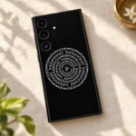 Black Indian mandala mobile skin with white Om and circular Devanagari mantra, linen flat lay