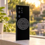 Black Indian mandala mobile skin with white Om and circular Devanagari mantra, golden window view