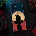 Itachi Moon mobile skin with black ninja silhouette and cream moon, night desk flat lay view