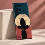 Itachi Moon mobile skin with black ninja silhouette and cream moon, rose limestone studio view