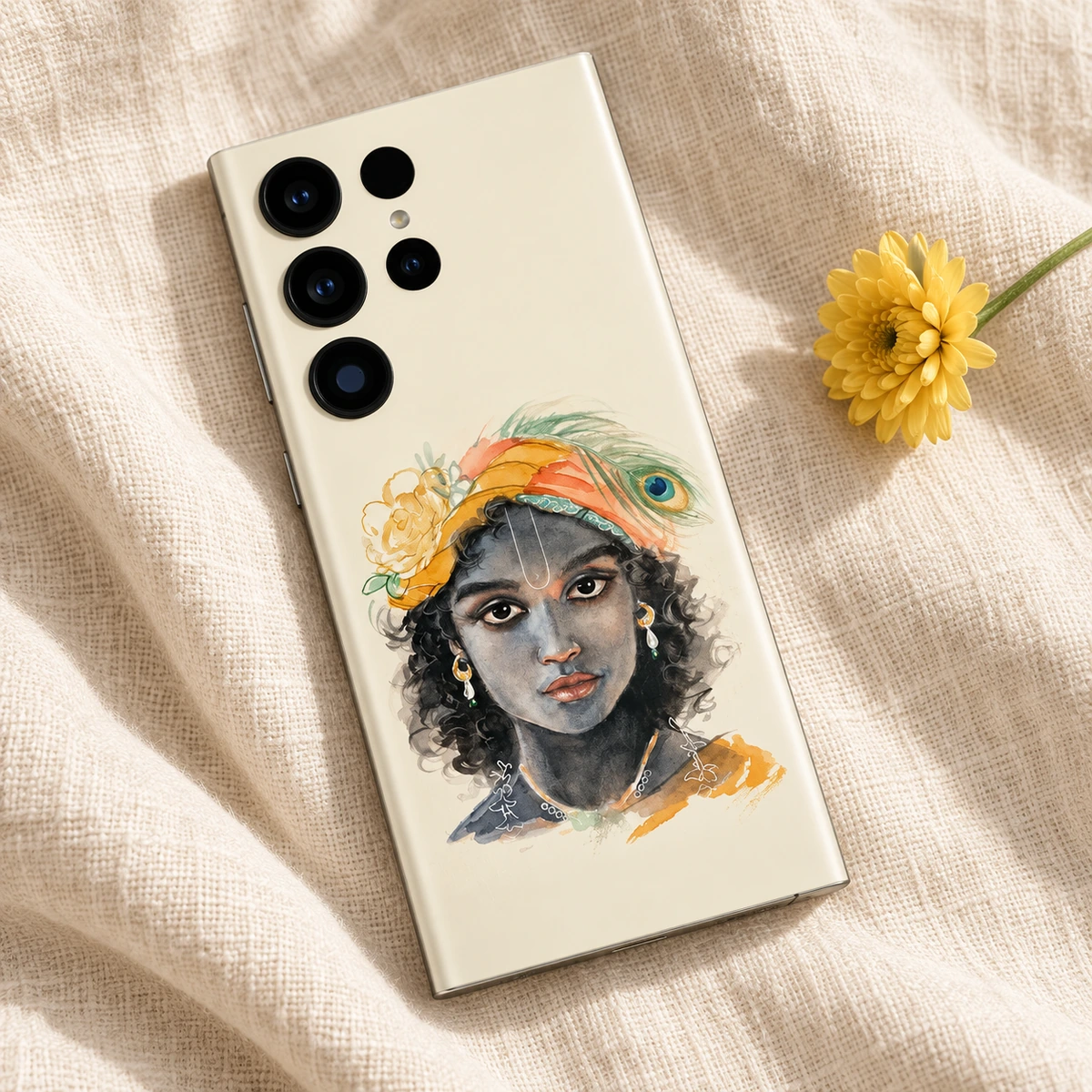 Kanha Watercolour Portrait Mobile Skin - Linen flatlay Cream Kanha portrait mobile skin flat lay on natural linen beside a yellow flower