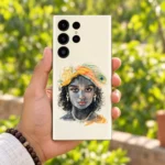 Kanha watercolour portrait mobile skin held in hand against a green garden