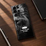 King lion motivational mobile skin with crown and quote in walnut desk flat lay
