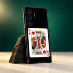 Black King of Hearts card mobile skin with red K symbols, studio side angle