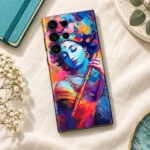 Krishna mobile skin with colourful blue portrait and golden orange flute, linen flat lay