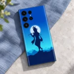 Krishna flute and moon mobile skin flat lay on blue linen