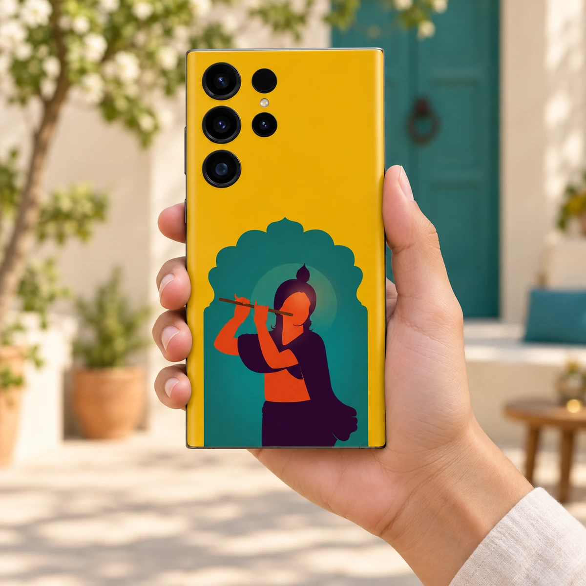 Krishna Teal Arch Mobile Skin - In Hand Krishna teal arch mobile skin held in hand in a bright courtyard