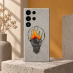 Grey mobile skin with a hand-drawn light bulb containing mountains and orange-yellow illustrated flames, concrete art studio hero