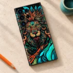 Lion Art Mobile Skin with an orange and teal ornamental lion face, art studio flat lay