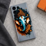Lord Ganpati mobile skin with teal elephant portrait, orange crown and splatter artwork, concrete flat lay