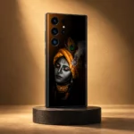 Black Lord Krishna portrait mobile skin with saffron turban on a charcoal pedestal in amber studio light
