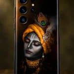 Close view of monochrome Krishna face with saffron turban peacock feather white tilak and gold jewelry on black mobile skin
