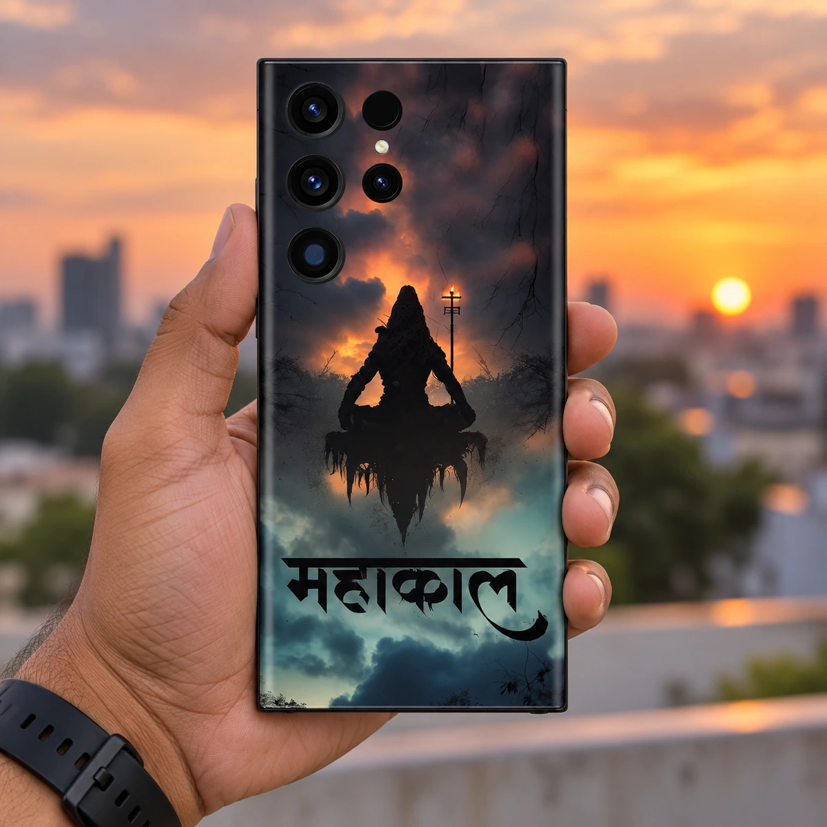 Mahakal Meditation Mobile Skin - in hand Mahakal mobile skin with Shiva silhouette and Hindi calligraphy held upright at sunset